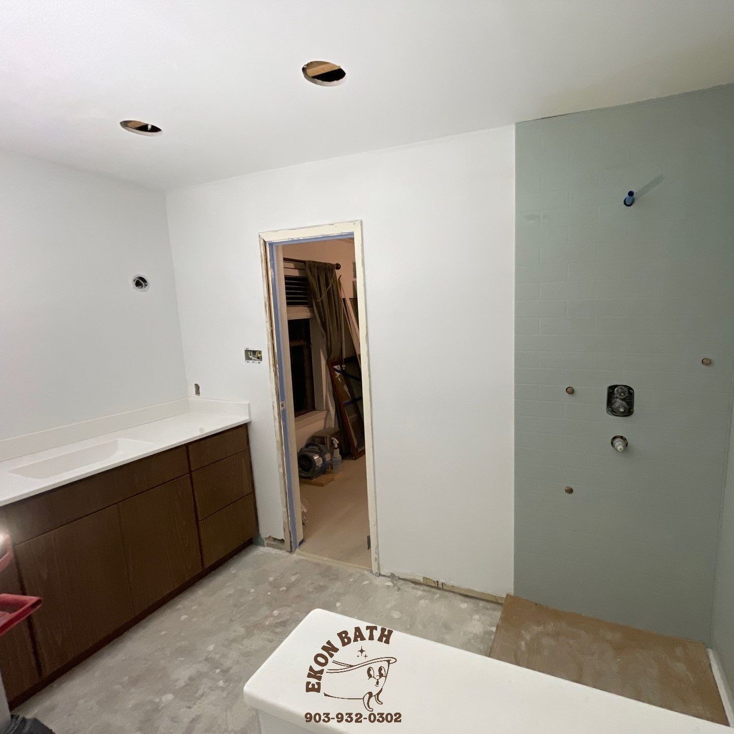 A bathroom under construction with a sign that says eko bath