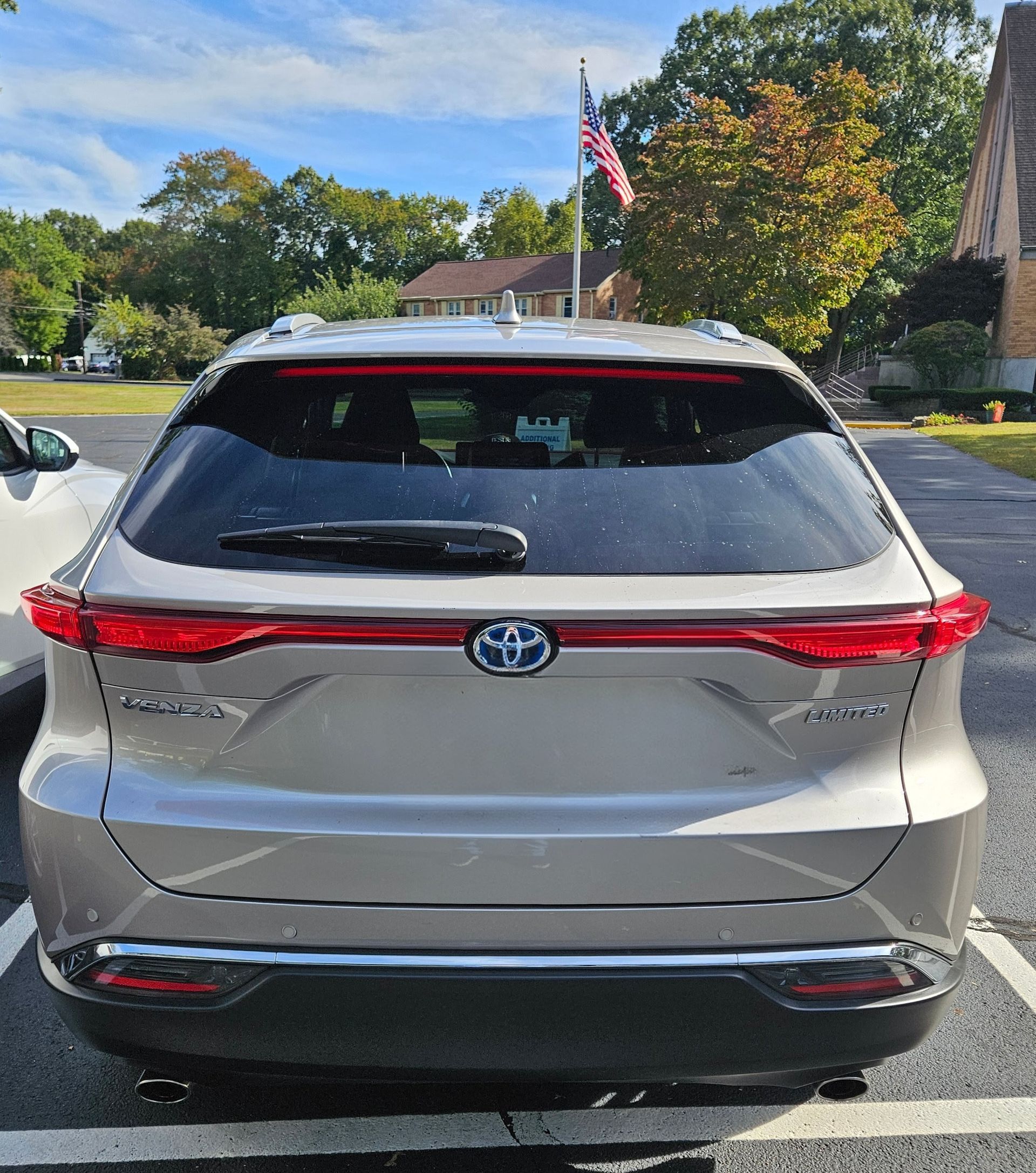 Rear view of a silver Toyota SUV parked in a lot, with a Florida license plate and trees in the background