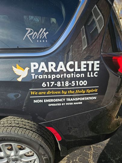 Paraclete Transportation LLC logo and contact info on a black vehicle door with a bird icon.