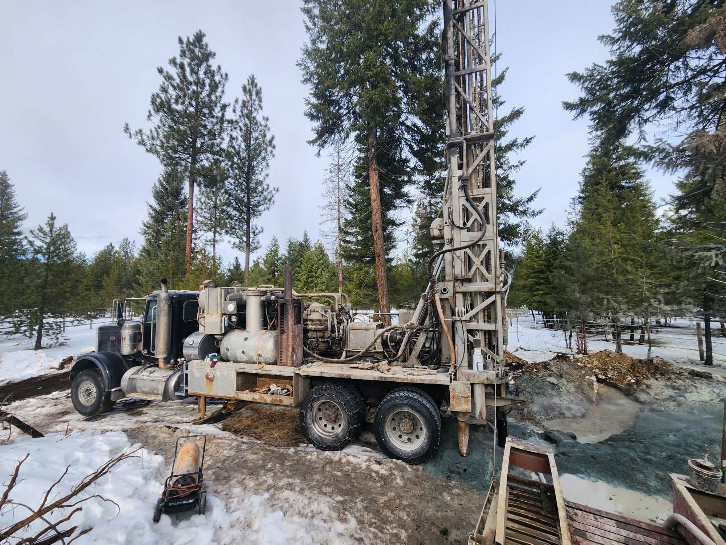 A Truck Is Driving Through A Snowy Field With Trees | Thompson Falls, MT | North Star Drilling Inc.