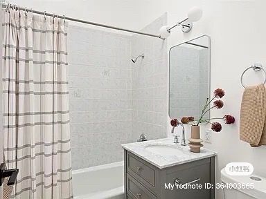 A modern bathroom featuring a shower, vanity, and decorative elements; white and gray color scheme.