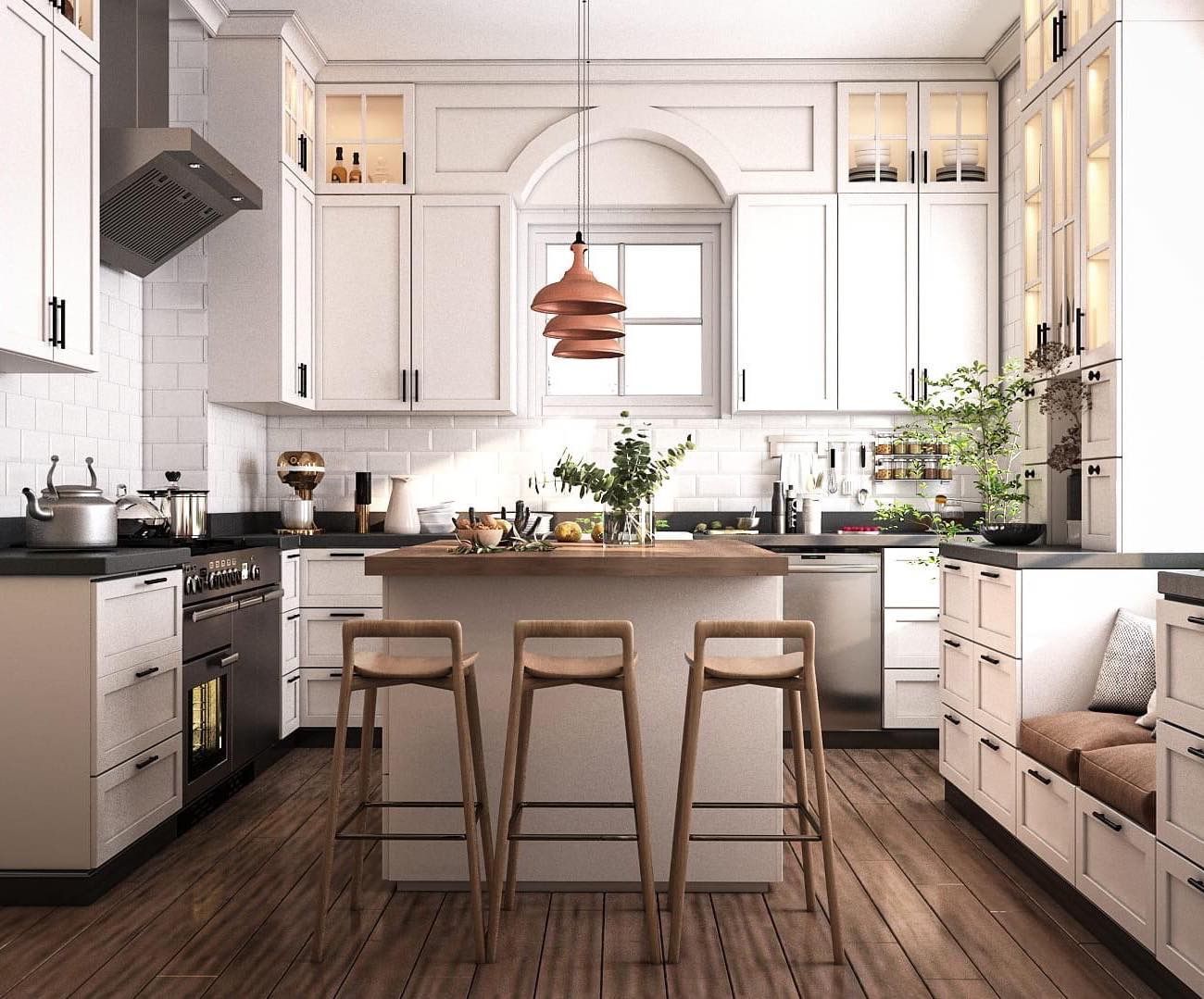 Stylish white kitchen with island, wooden stools, and copper pendant lights.