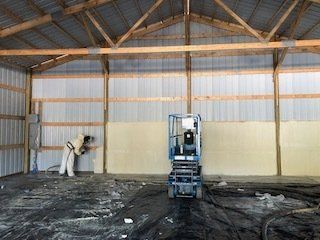 Worker Spraying Foam on the Wall — Medford, OR — All Phase Weatherization & Construction LLC