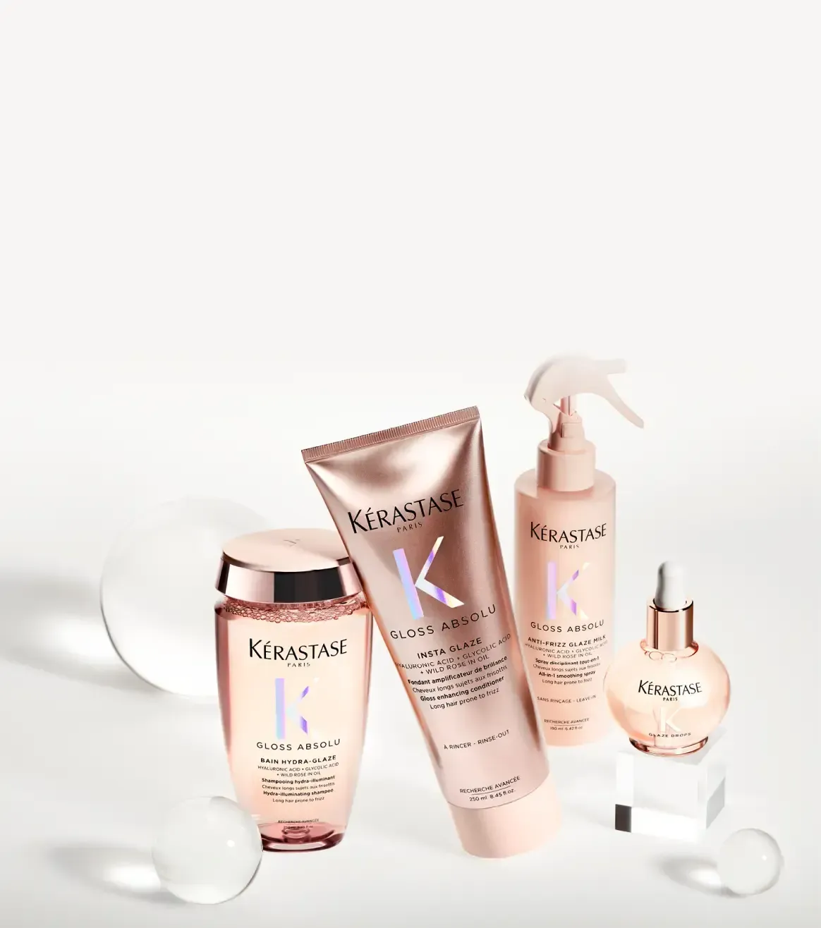 A group of bottles of kerastase hair products are sitting on a table.