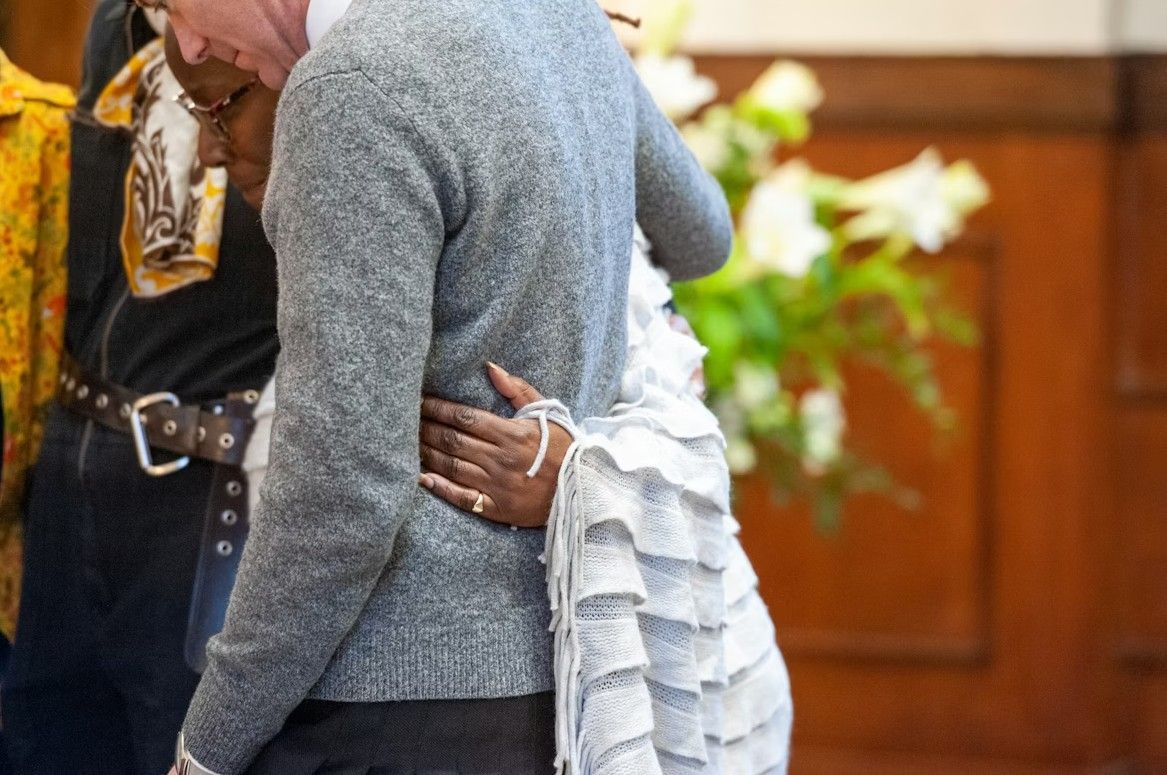 Family embracing during a memorial service, reflecting comfort and support while helping families move forward with confidence in Weymouth, MA funeral and cremation services