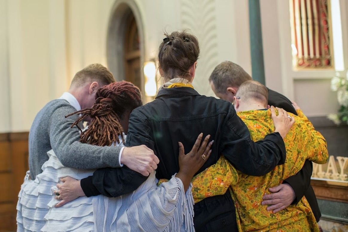 Family embracing during a memorial service, reflecting a trusted local team for families and compassionate Quincy, MA funeral and cremation services