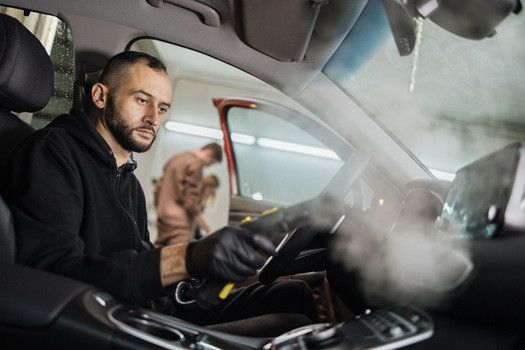 Technician working on smog inside of car | Euro Auto Tech & Smog