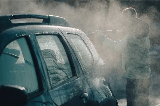 Technician performing cleaning on vehicle | Euro Auto Tech & Smog Offers Oil Smog Inspection in San Diego County