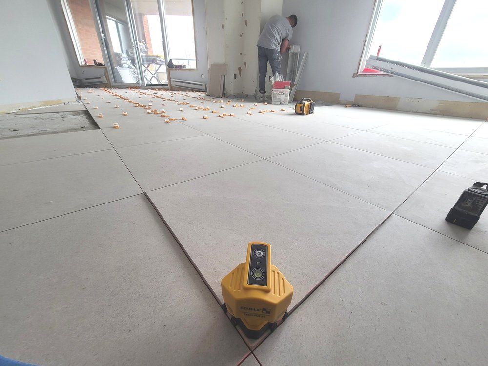 A yellow device is sitting on a tiled floor in a room.