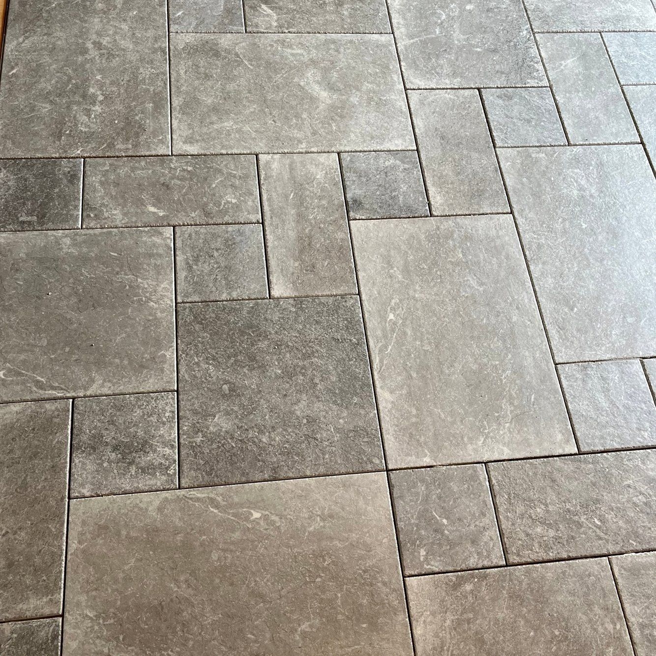 A close up of a tiled floor with a diagonal pattern
