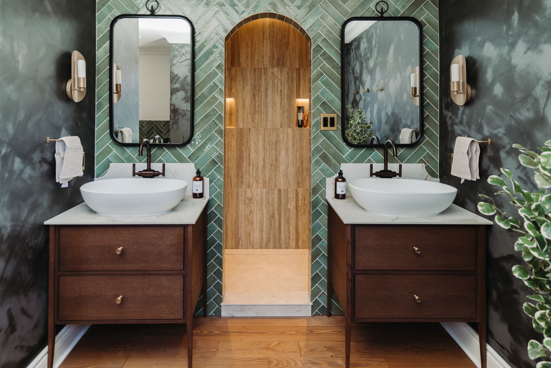 A bathroom with two sinks and two mirrors.