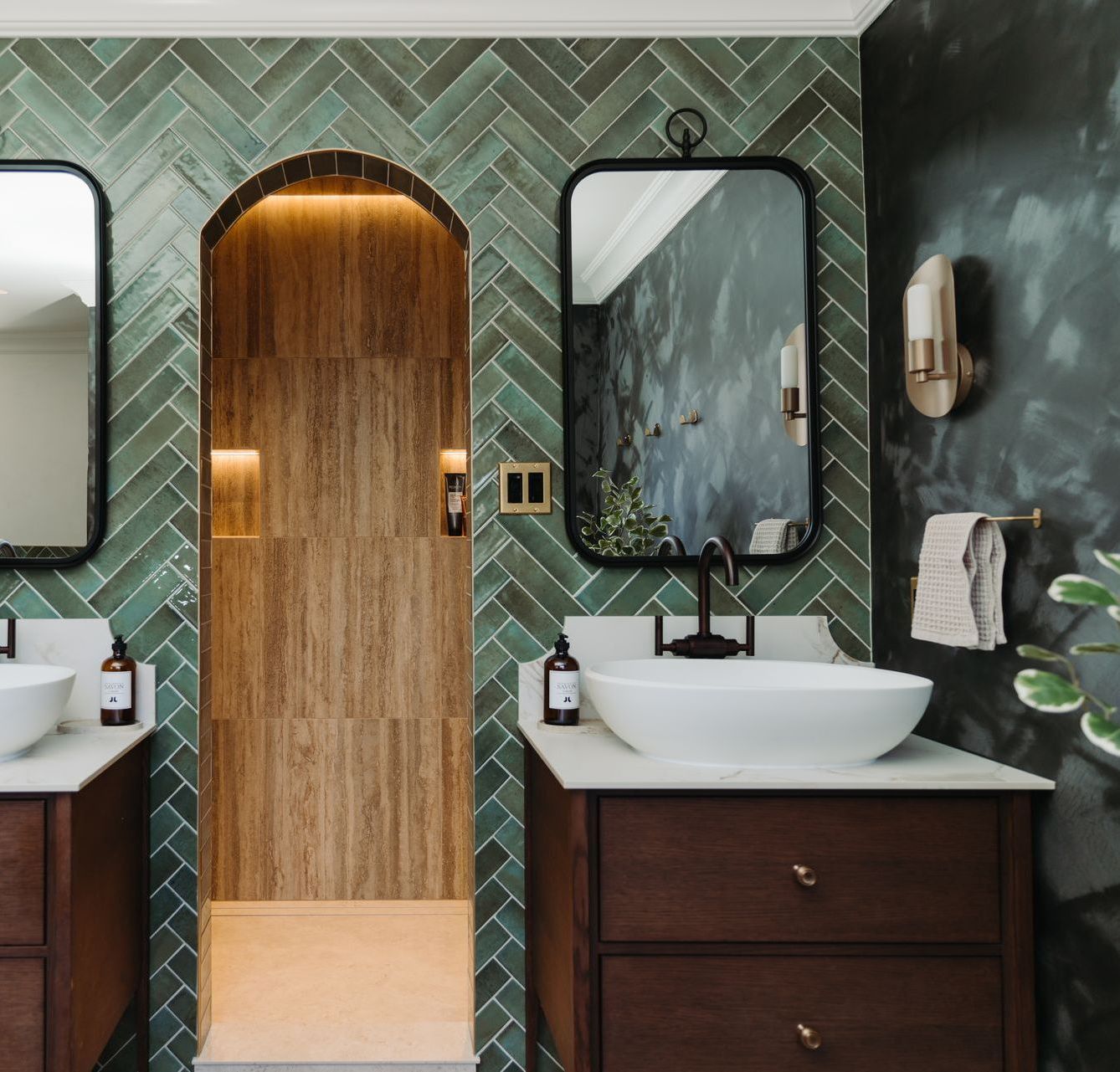 A bathroom with two sinks and two mirrors