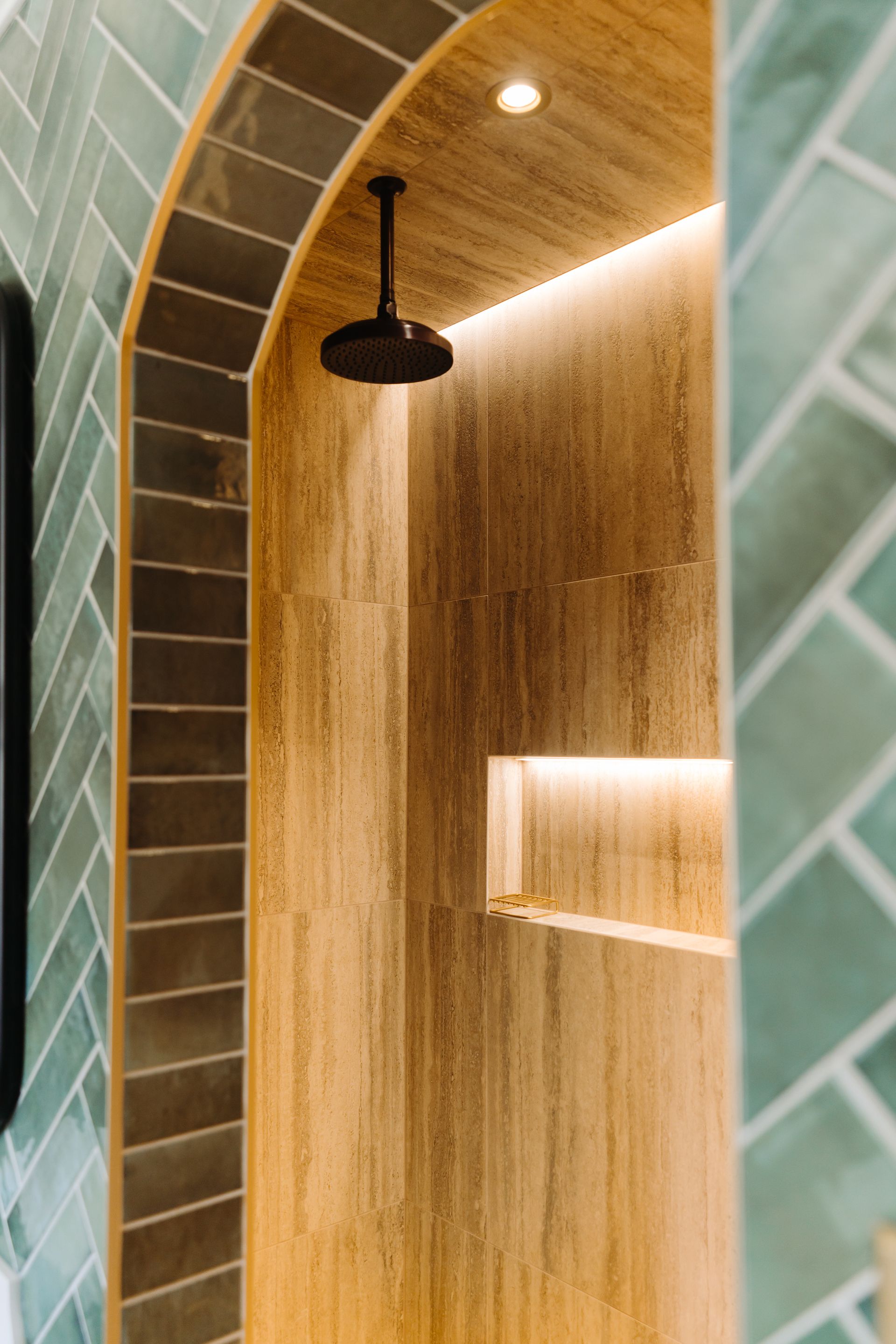 A bathroom with a shower head hanging from the ceiling.