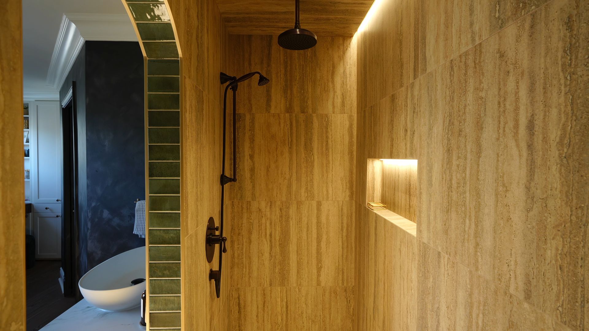 A bathroom with a walk in shower and a sink.
