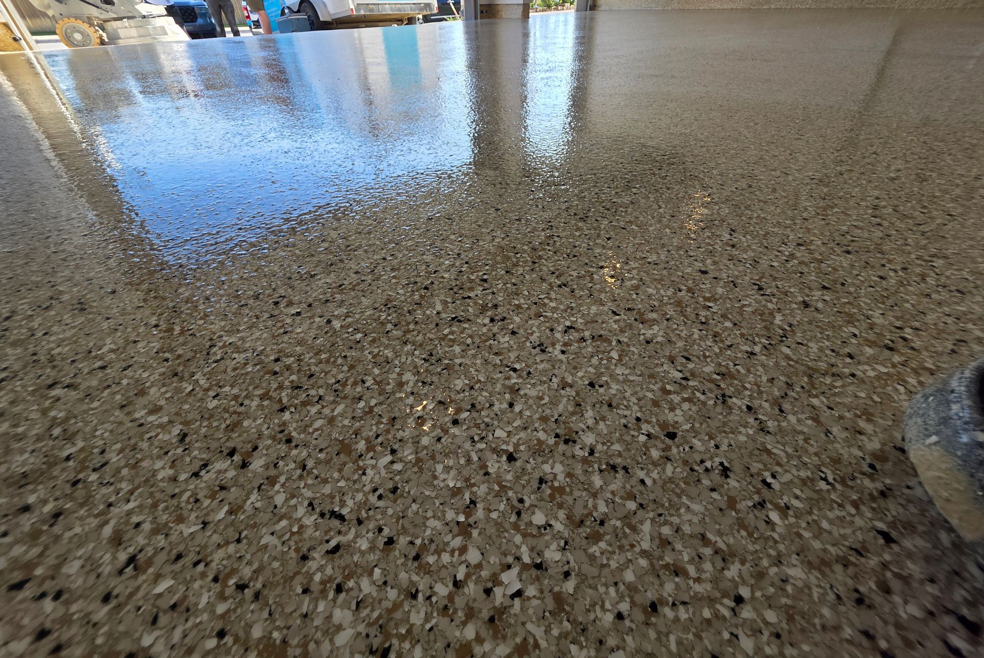 Polished speckled terrazzo floor reflecting windows and light in an indoor space