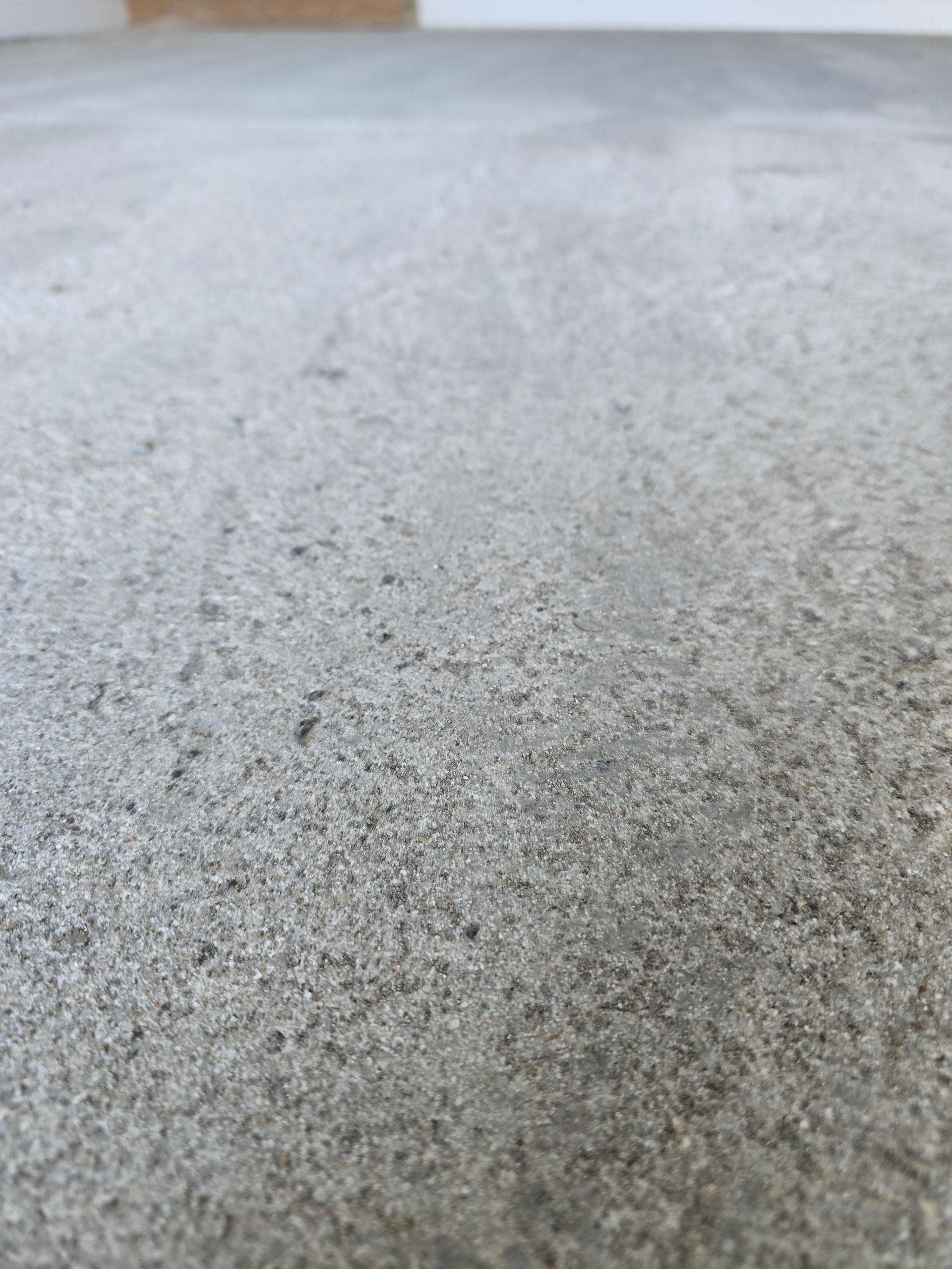 Close-up of a gray textured concrete surface with a blurred background