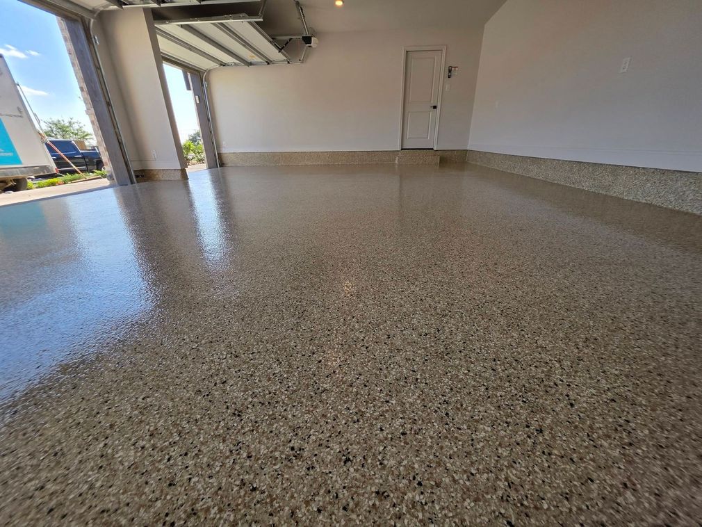 Empty covered patio with speckled epoxy floor and open view outside