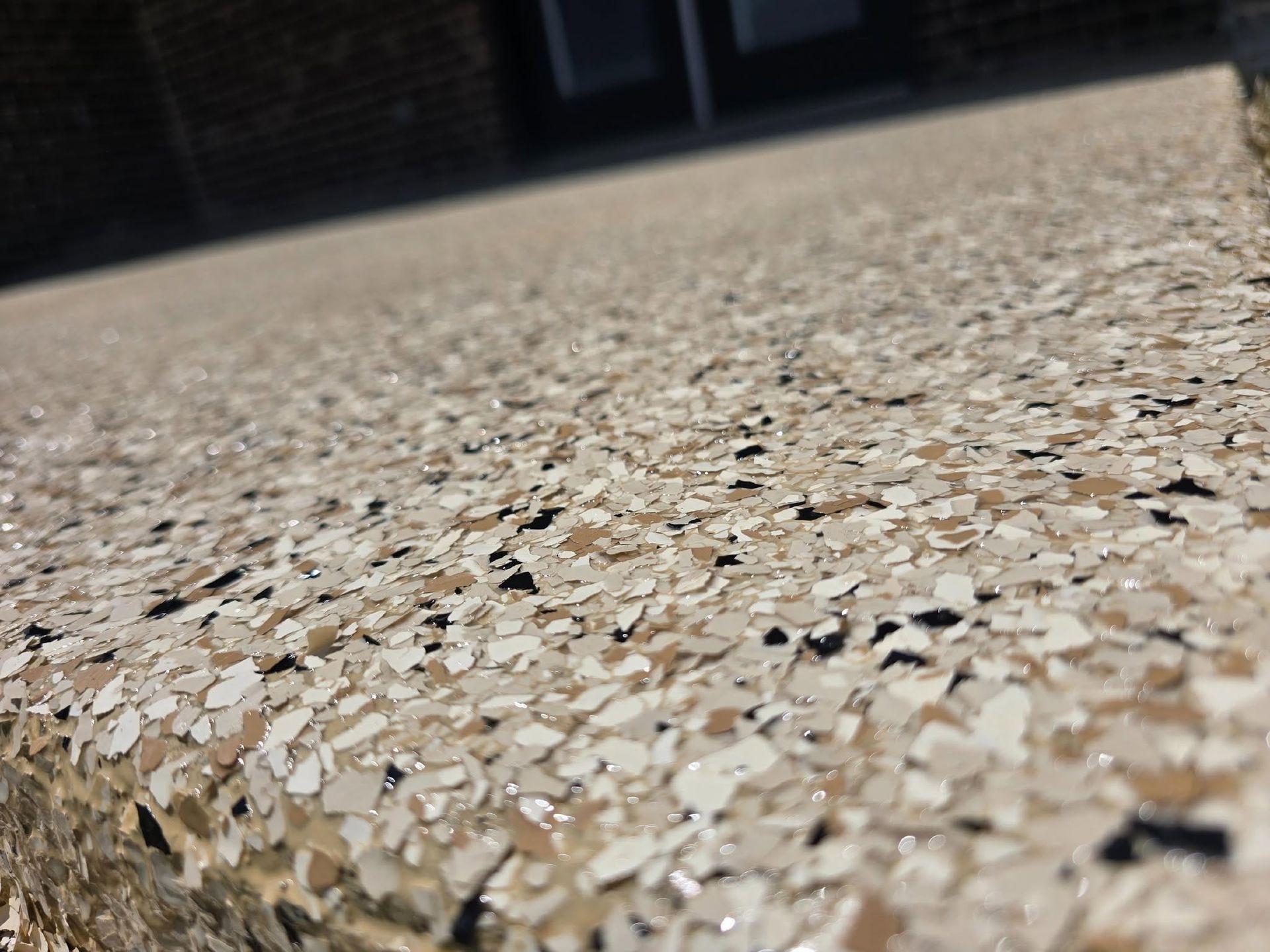 Speckled terrazzo floor with shallow depth of field and blurred background lights