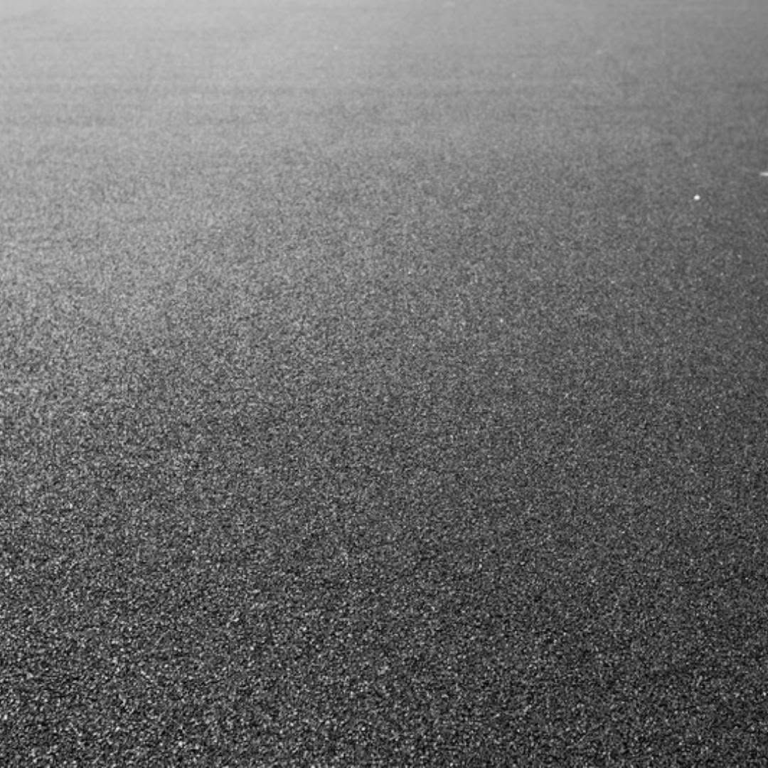 Close-up of a gray, textured surface fading lighter toward the top.