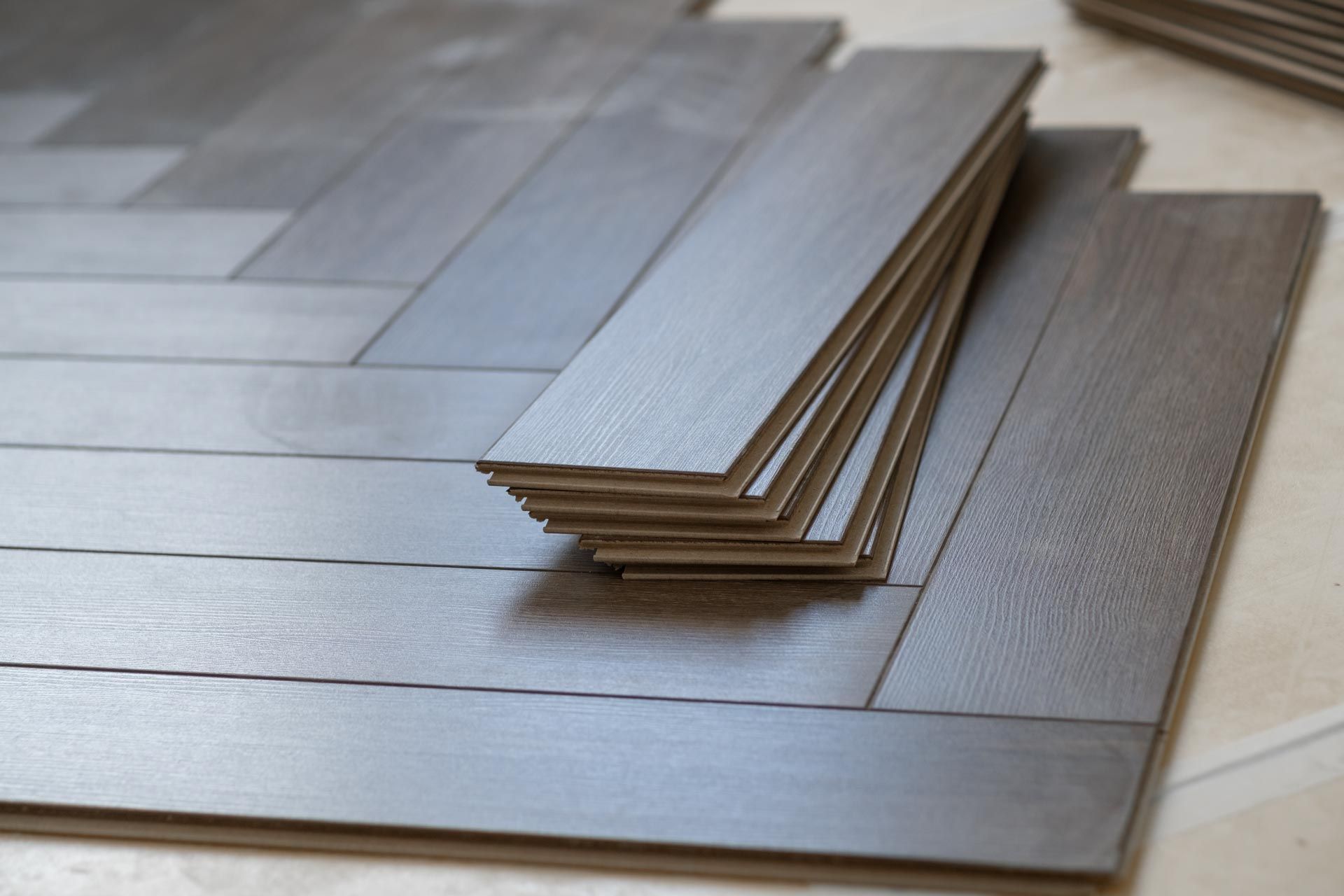 A row of yellow tiles on a gray tiled floor.