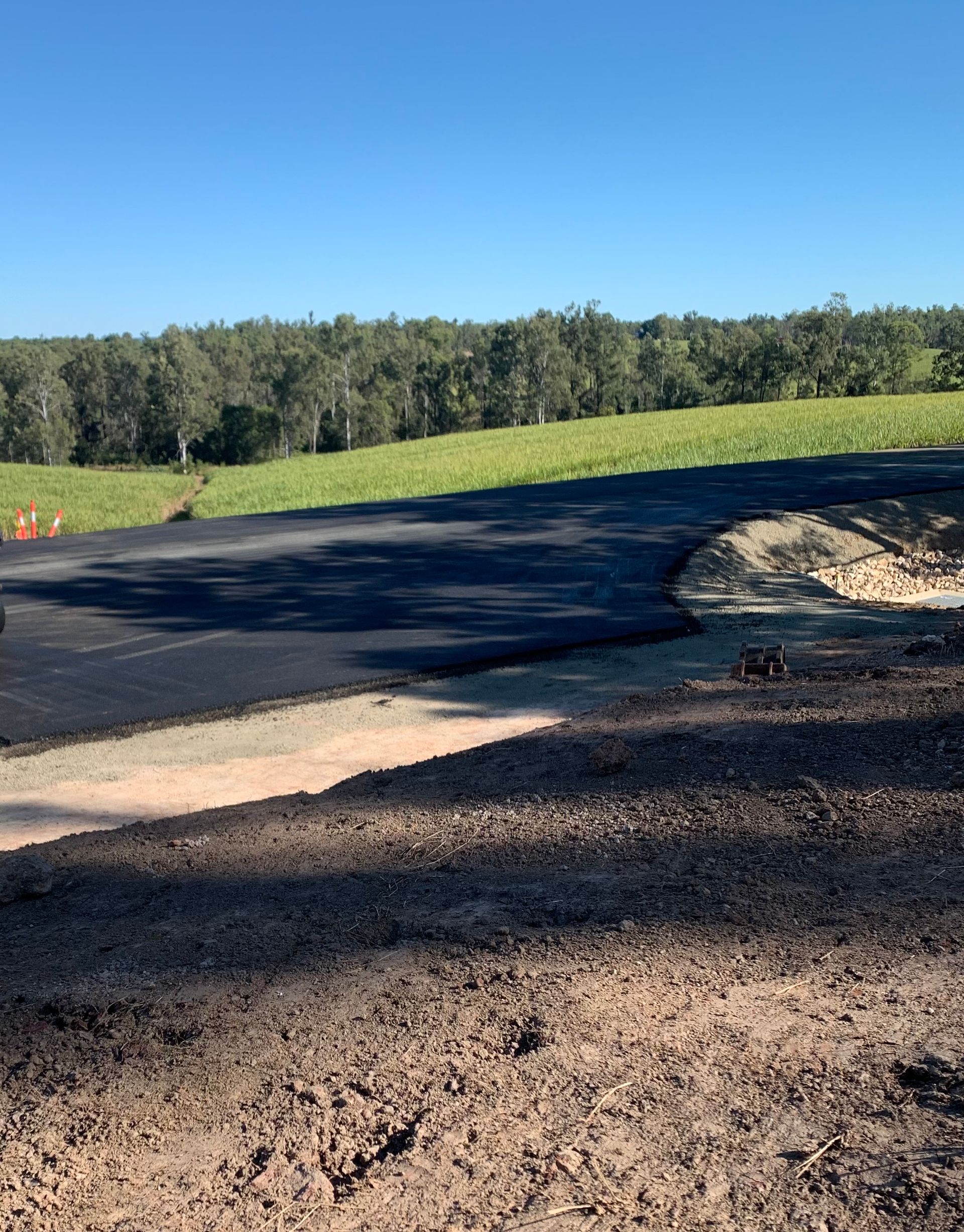 A Group Of Men Are Working On A Patch Of Asphalt — Appian Roads In Herbey Bay, QLD