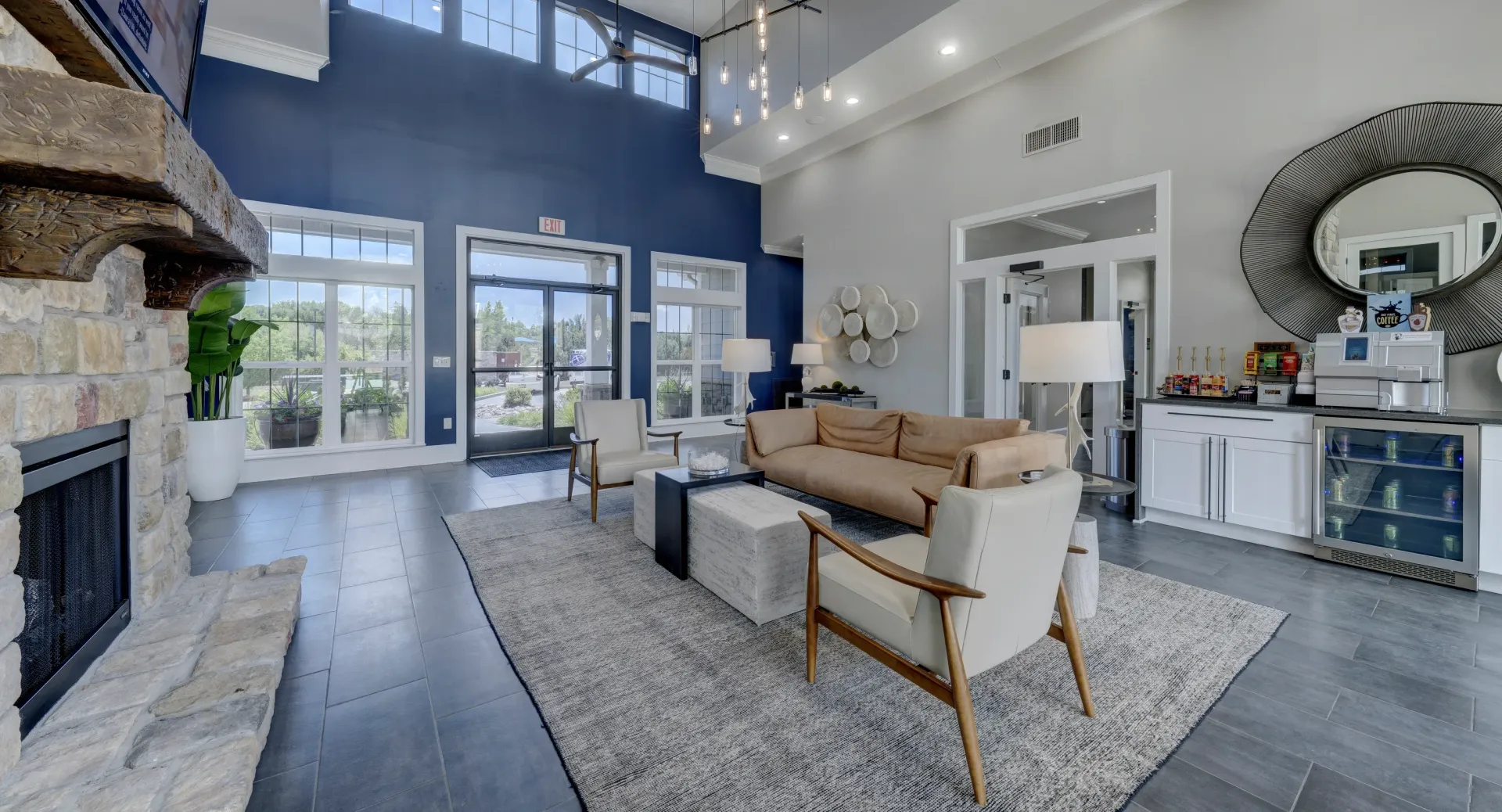 Spacious lounge area with a stone fireplace, comfortable seating, and a coffee bar.