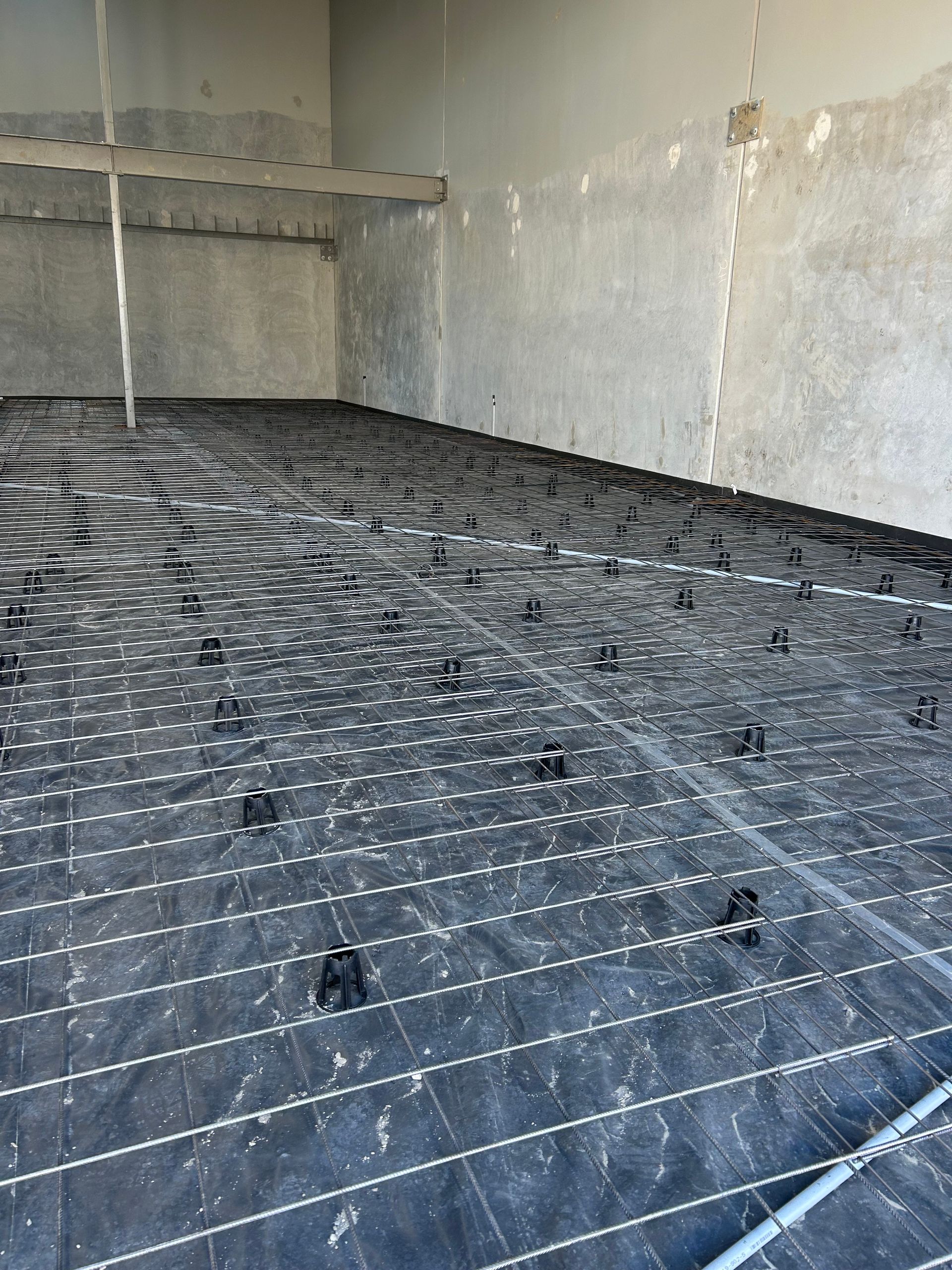 A large room with a lot of wires on the floor.