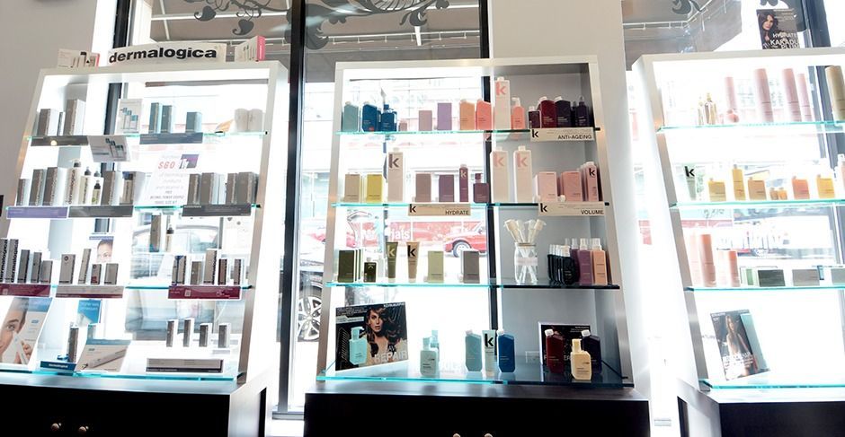 Brightly lit store display shelves filled with assorted cosmetics and skincare products.