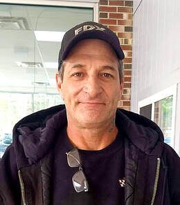 A person wearing a black cap with