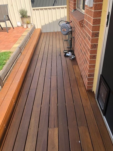 Wooden Deck With a Brick Wall — Hancock Construction & Maintenance in Newcastle, NSW
