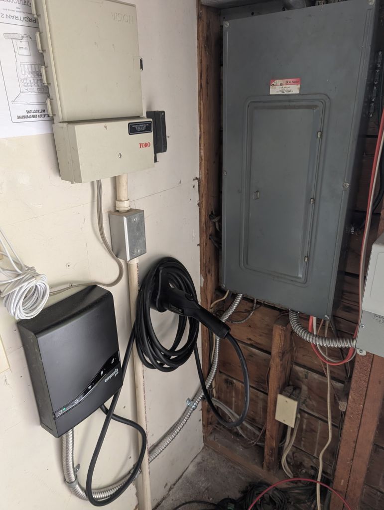 Electrical panels and wiring mounted on a utility room wall.