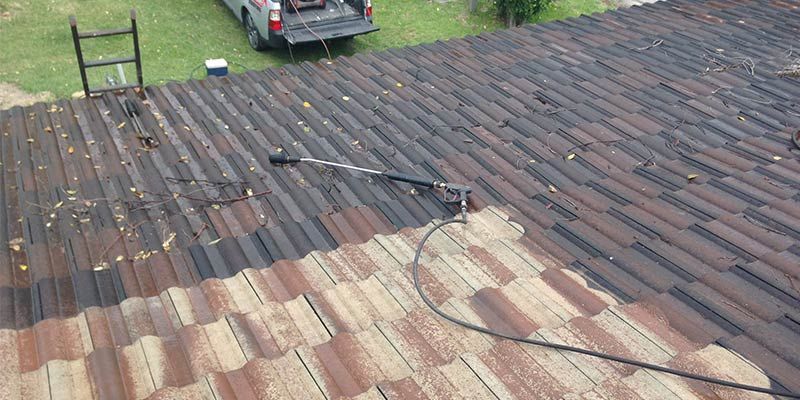 A Car Is Parked On The Roof Of A House — In-Time Roofing In Newcastle, NSW
