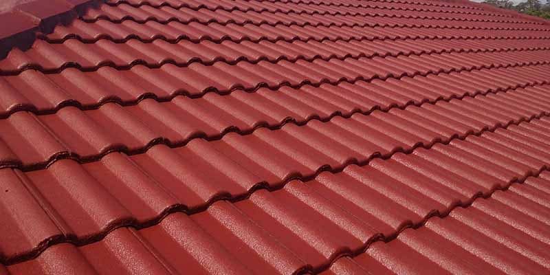 A Close Up Of A Red Tiled Roof On A House — In-Time Roofing In Newcastle, NSW
