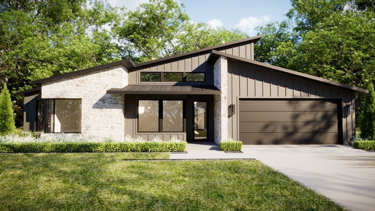 Modern house with gray and stone exterior, surrounded by green grass and trees.