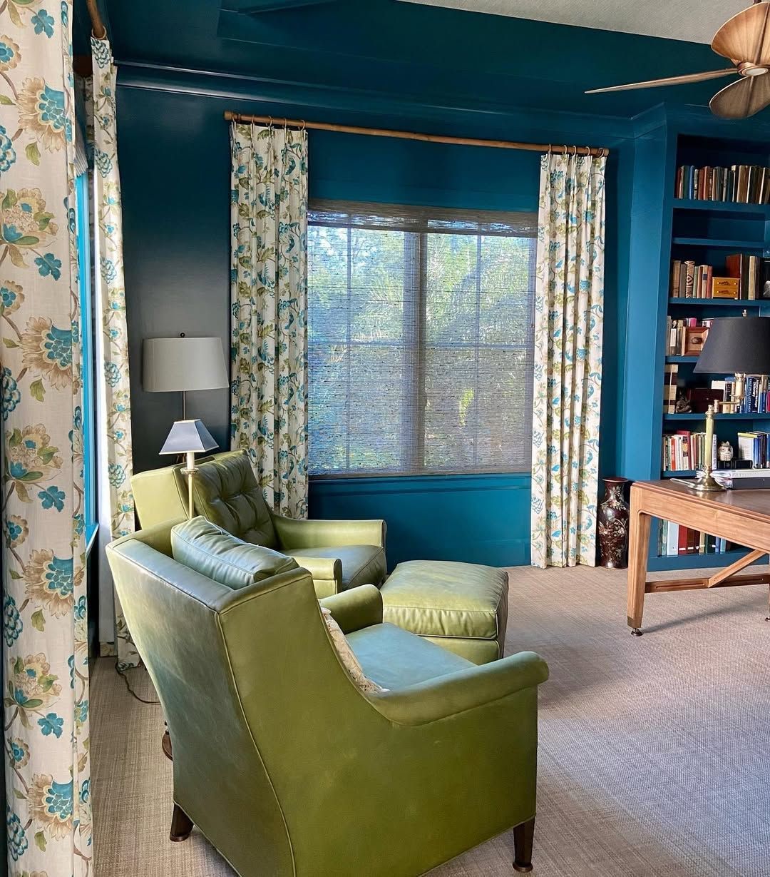 A living room with green chairs and blue walls