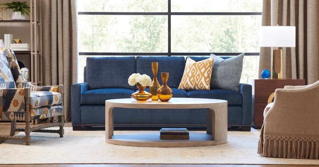 A living room with a blue couch and a coffee table.