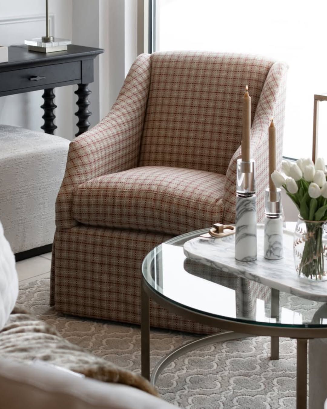 A living room with a chair and a coffee table