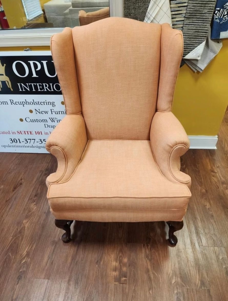 A chair is sitting in front of a sign that says opu interiors