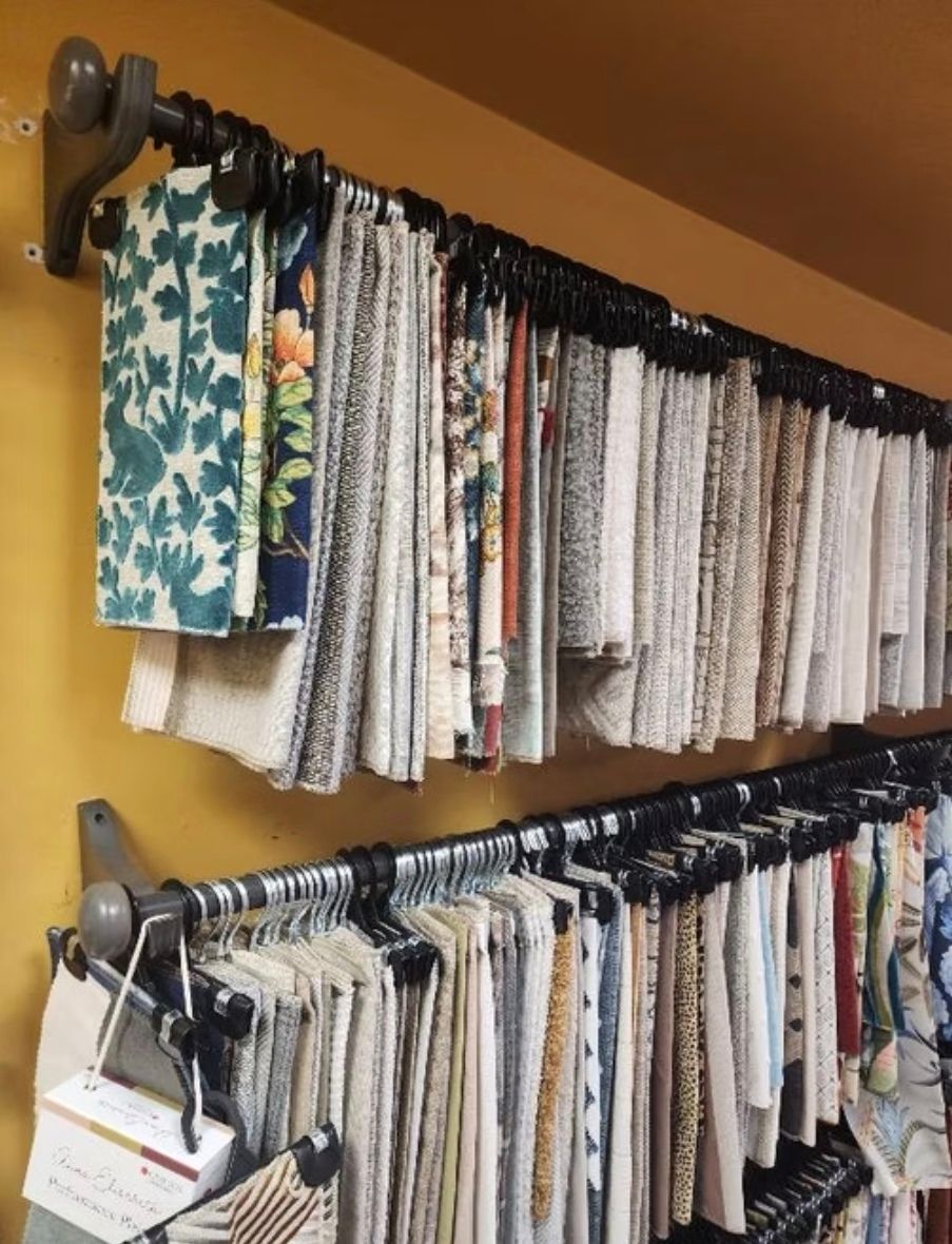 A bunch of fabric samples are hanging on a rack