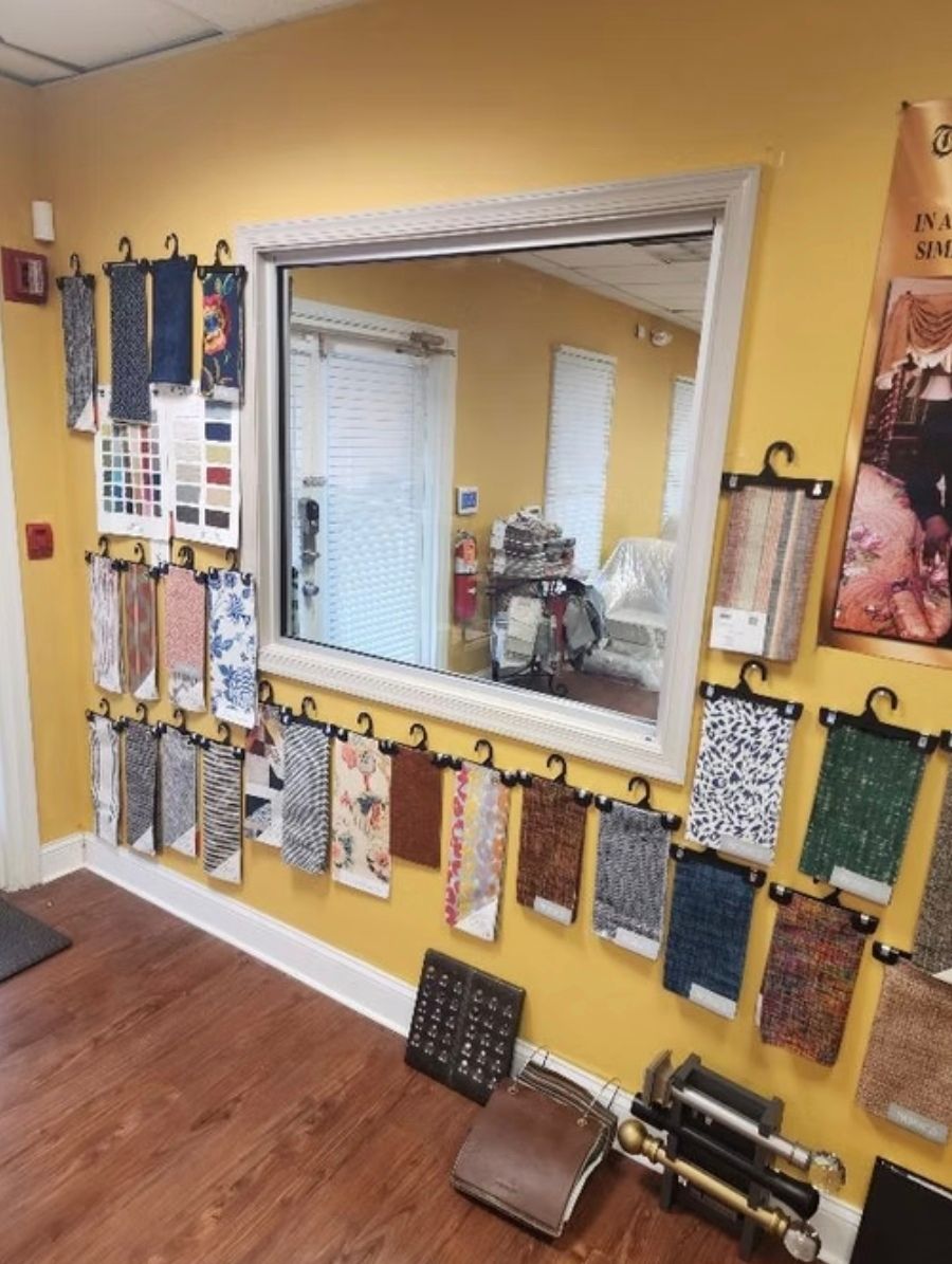 A room with a lot of fabrics hanging on the wall