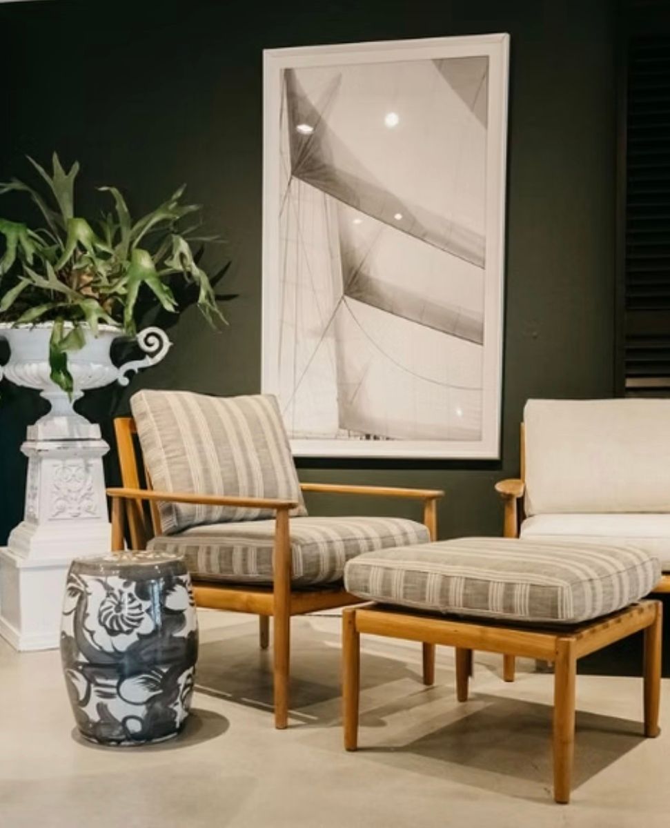 A living room with two chairs and an ottoman