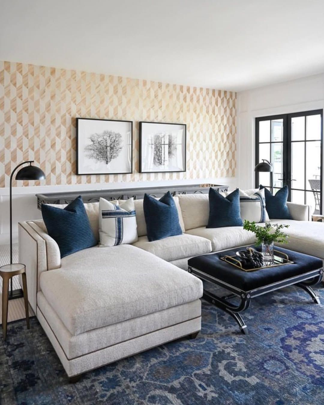 A living room with a large sectional couch and a coffee table.