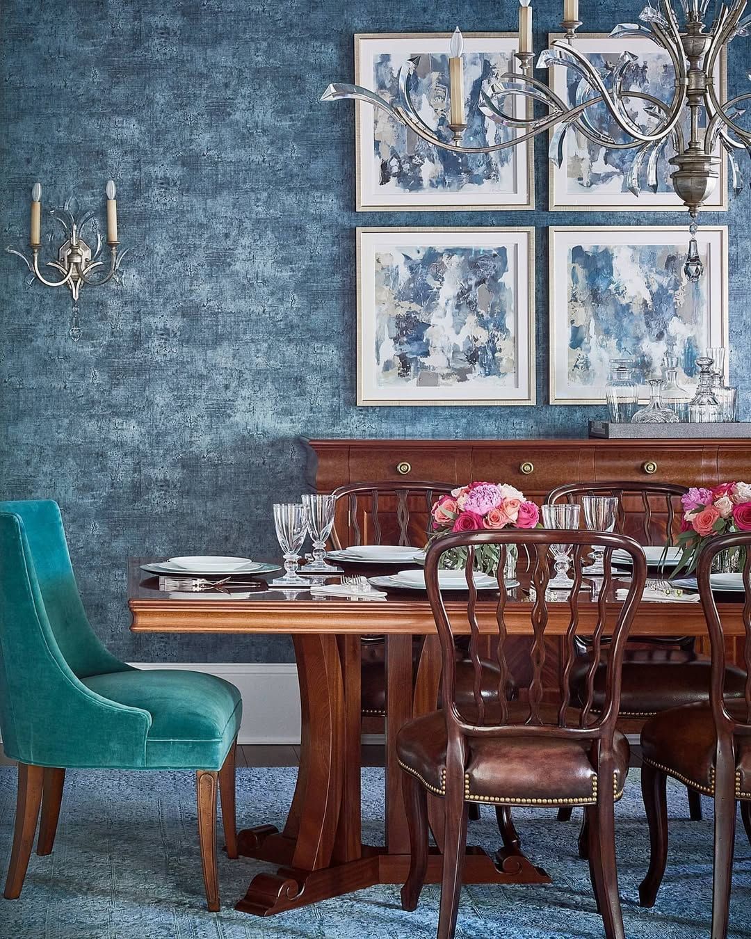 A dining room with a table and chairs and a chandelier