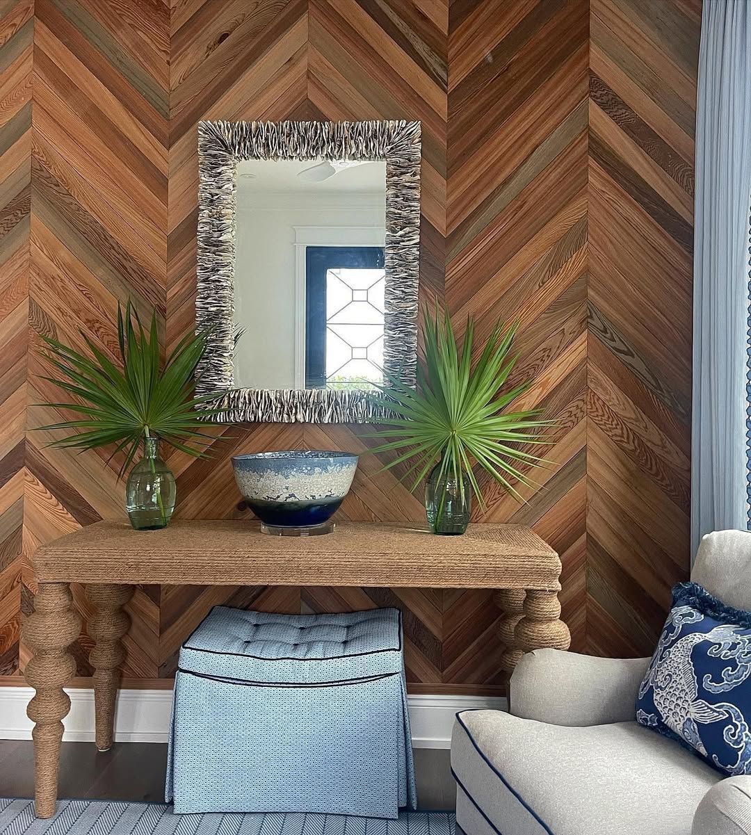 A living room with a wooden wall and a mirror