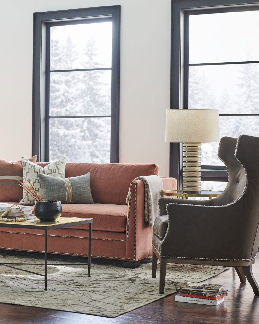 A living room with a couch , chair , table and lamp