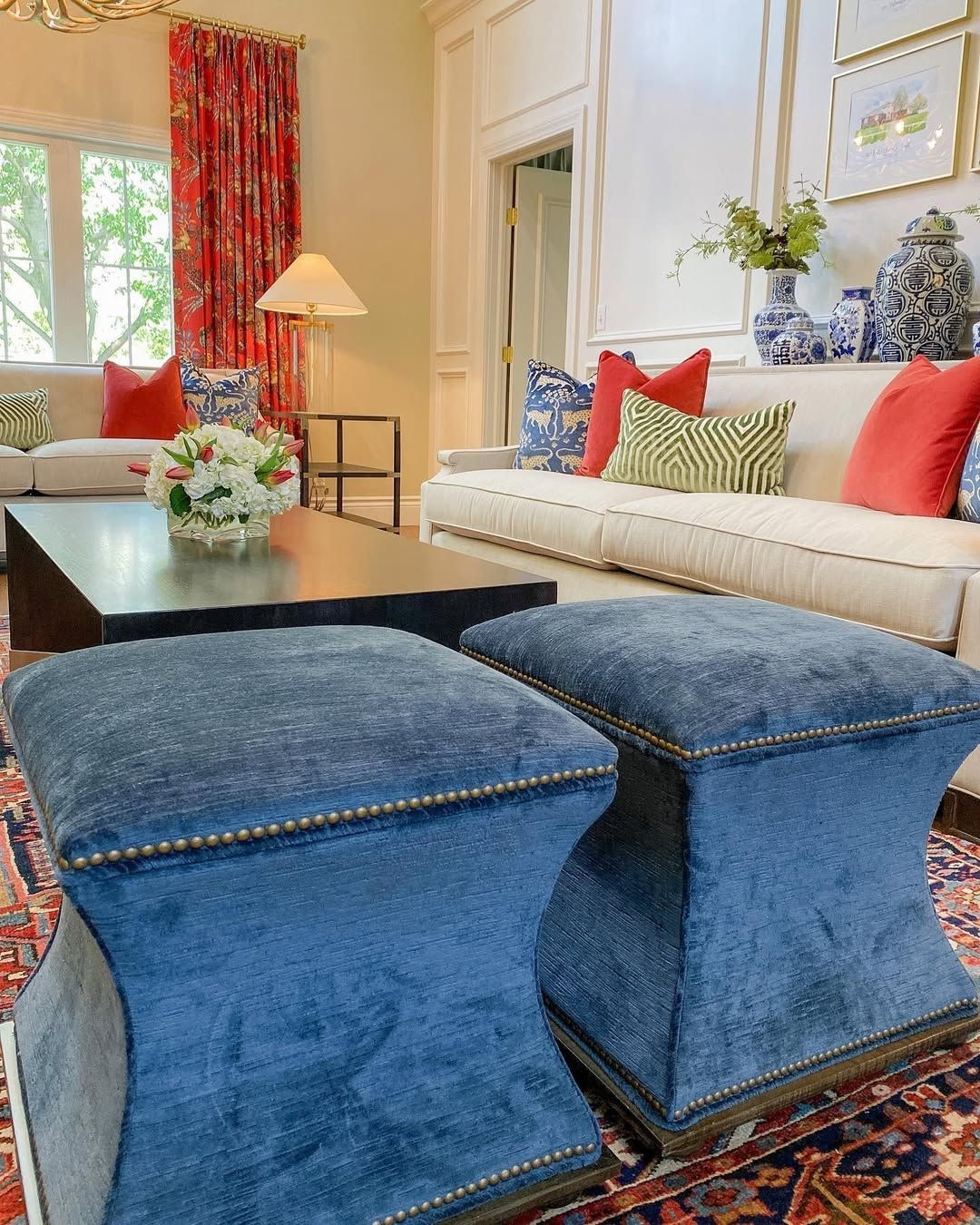 A living room with blue ottomans and a white couch