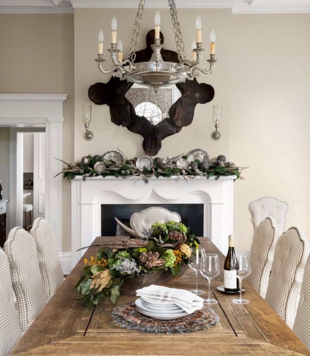 A dining room table with a bottle of wine on it