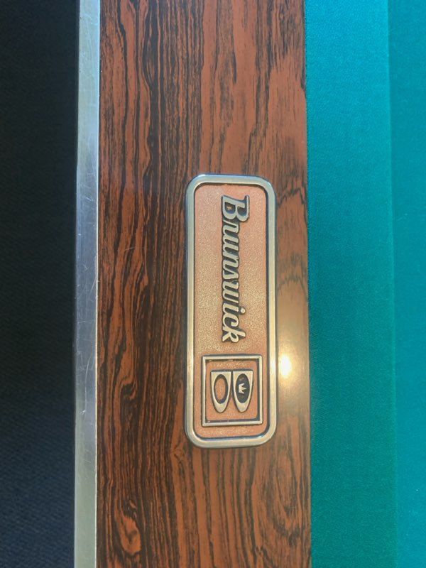 Close-up of a woodgrain Panasonic device label with a small black-and-silver logo
