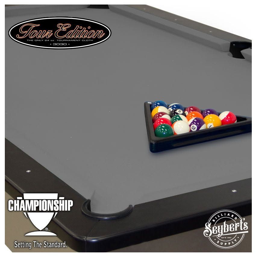 Gray championship pool table with racked billiard balls near the corner pocket