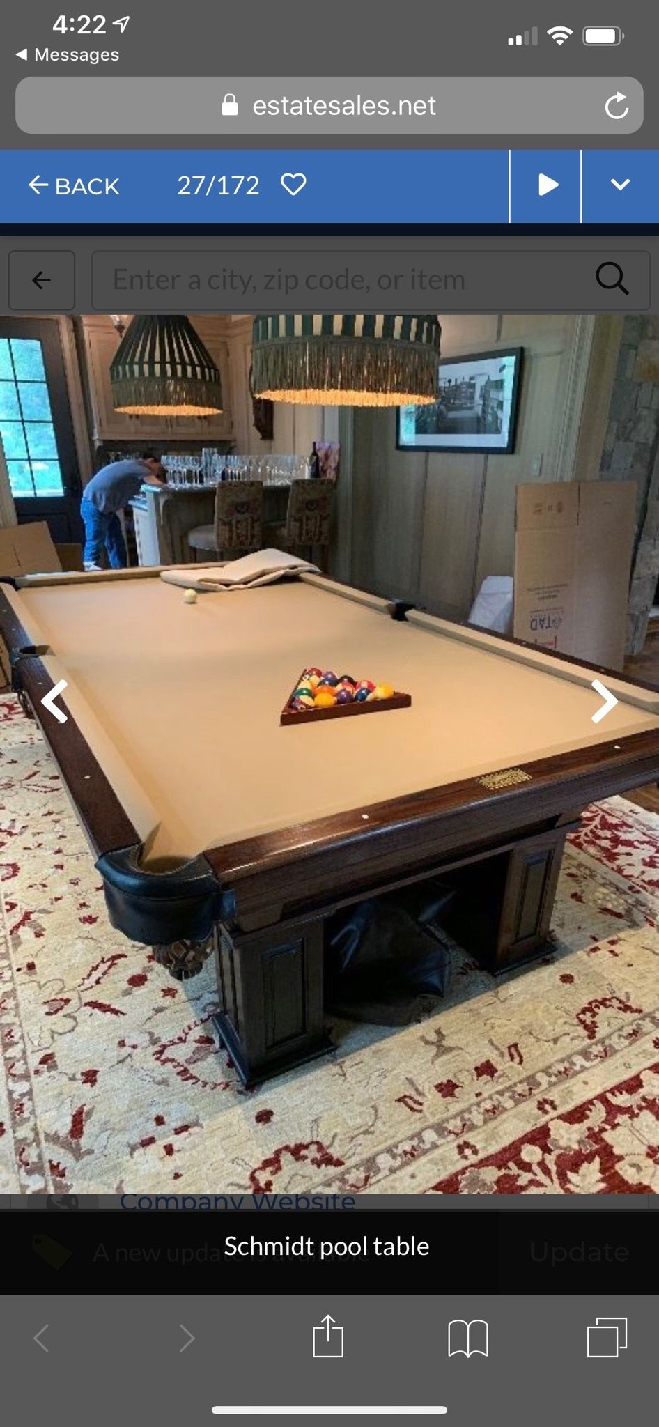 Air hockey table in a living room with a small toy on top and a patterned rug underneath
